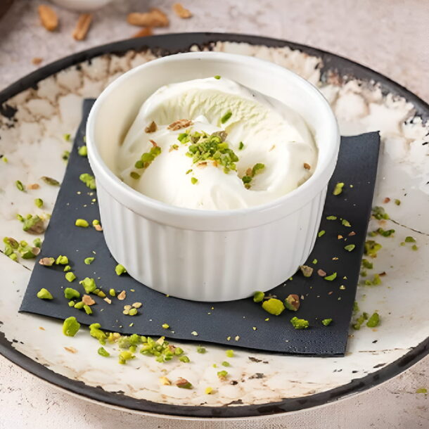 Traditional Turkish ice cream served in a white ramekin topped with crushed pistachios at Hatay Turkish Restaurant, Abu Dhabi.