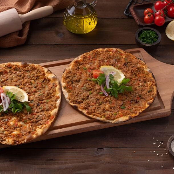 : Turkish lahmacun flatbread topped with minced meat and herbs