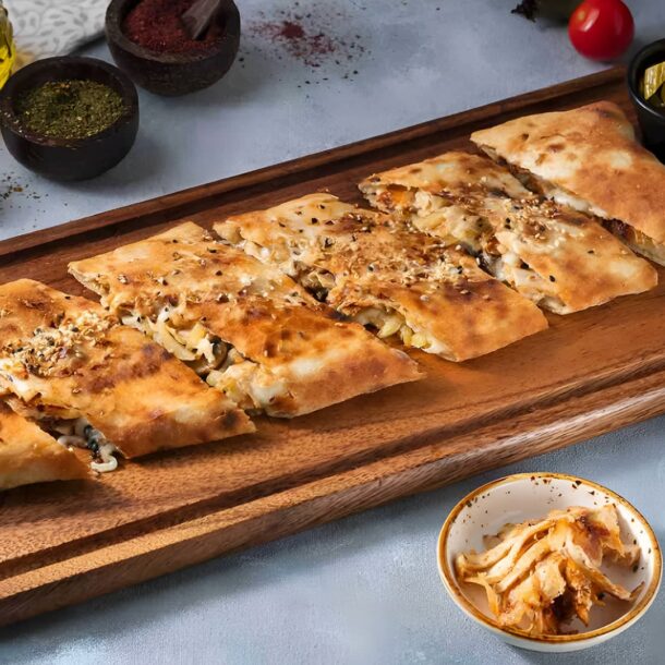 Shawarma plate with bread, garlic sauce, and tomatoes