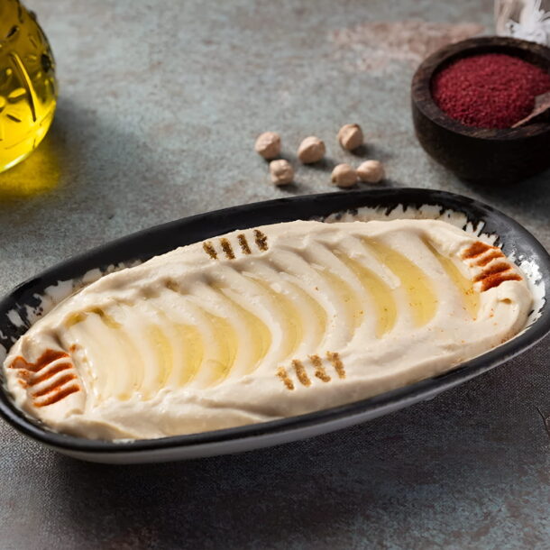 reamy hummus with olive oil and paprika garnish