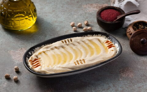reamy hummus with olive oil and paprika garnish